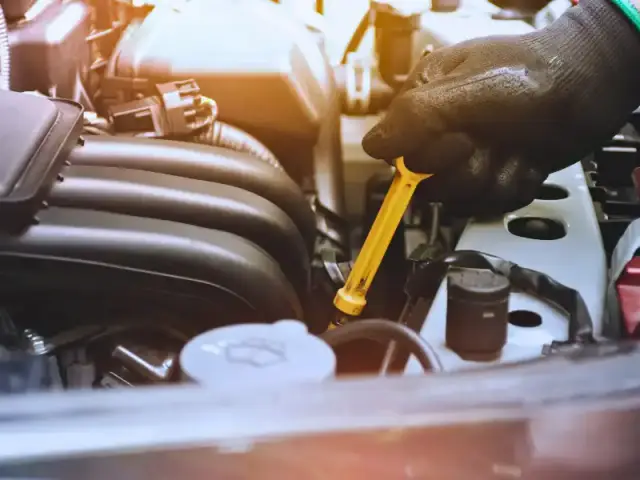 Mechanic performing wheel alignment to fix car pulling to one side